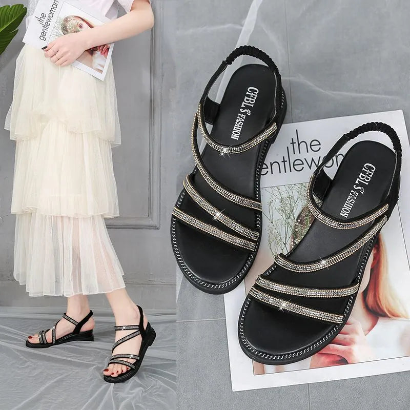 Women's silver flat sandals with rhinestone detail, round toe, and elastic band strap.