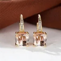 Square geometric ear hook studs with a round zircon stone, shown in a gold electroplated finish.