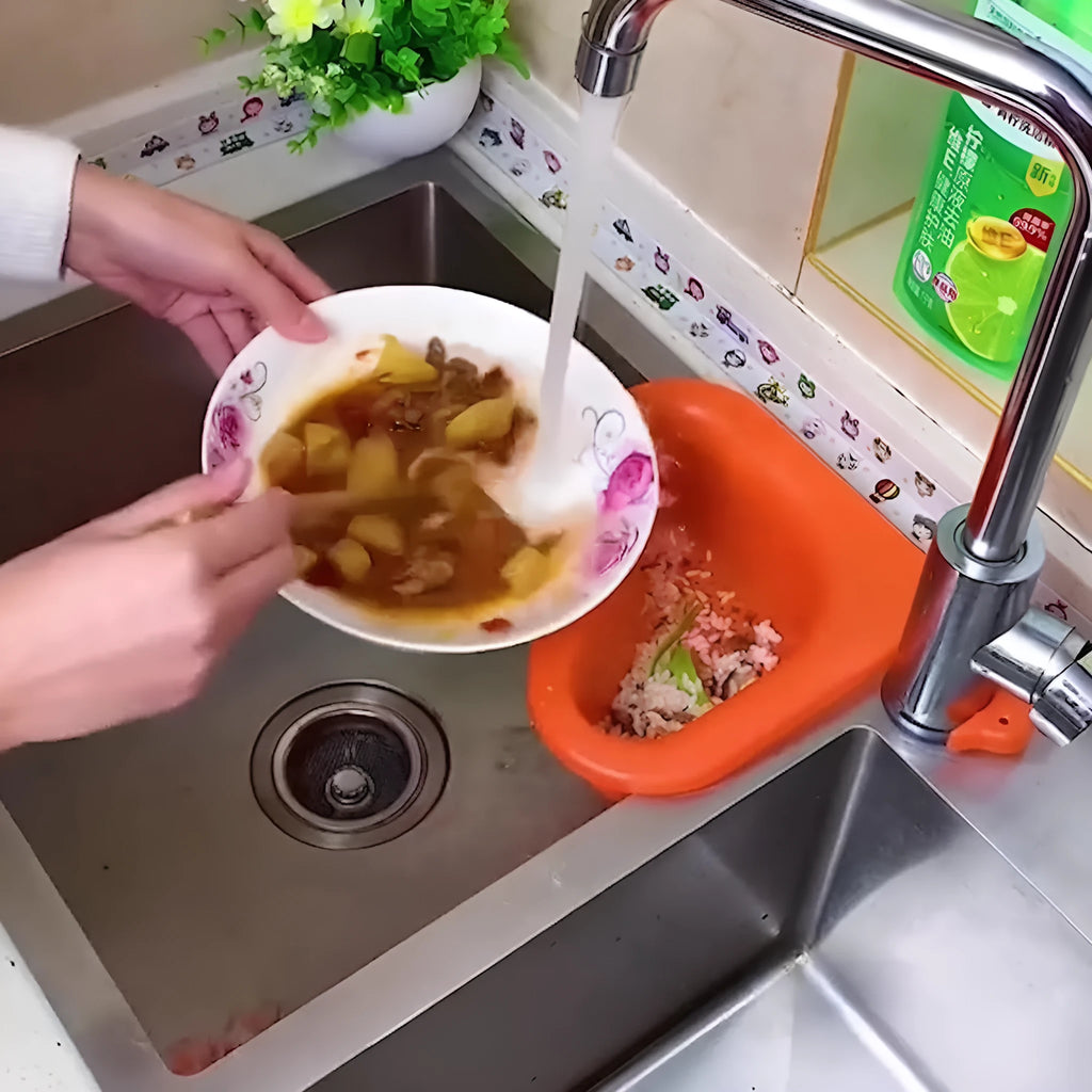 Yellow hanging swan drain basket made of plastic, fitted on a kitchen sink edge with space for vegetables and utensils