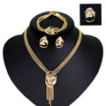 Gold alloy jewelry set with necklace, bracelet, earrings, and ring on a neutral background