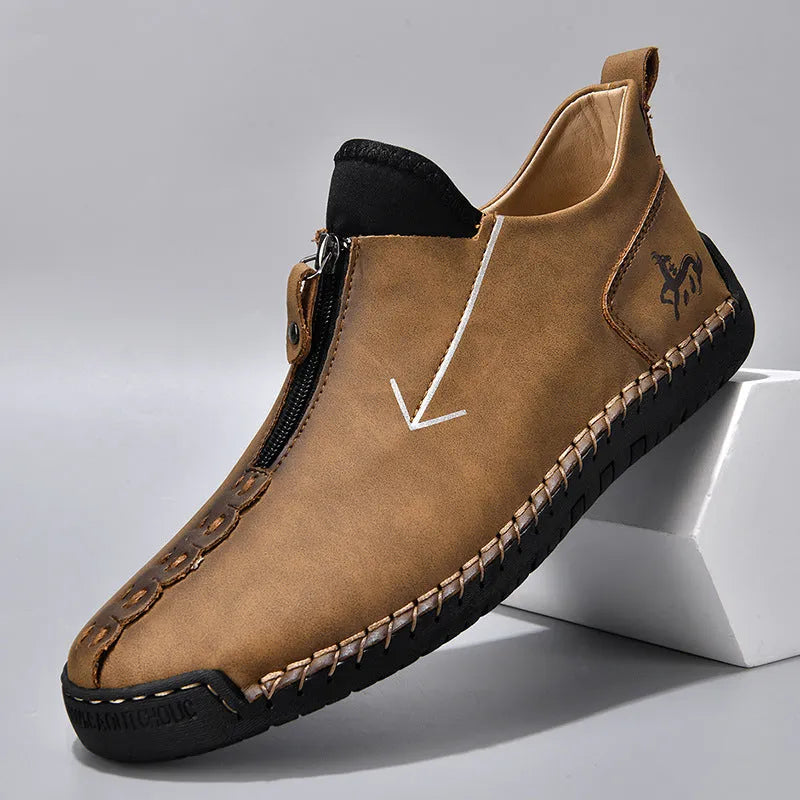 Men's black leather zip-up boots with round toe and hand-stitched rubber sole on a white background.
