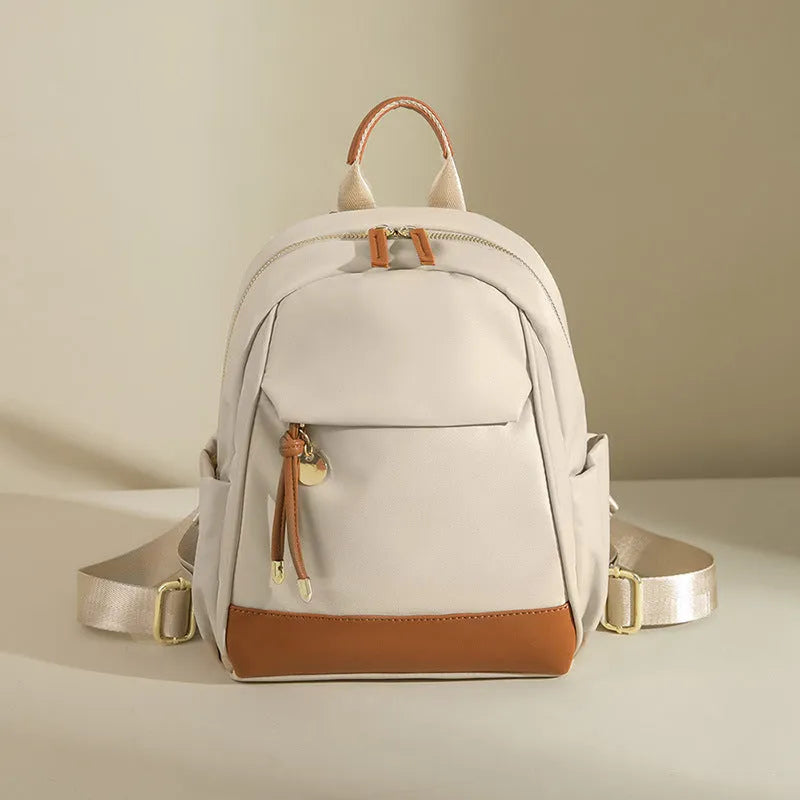 Women's double shoulder Oxford cloth backpack in almond colour with contrast stitching and open outer pocket