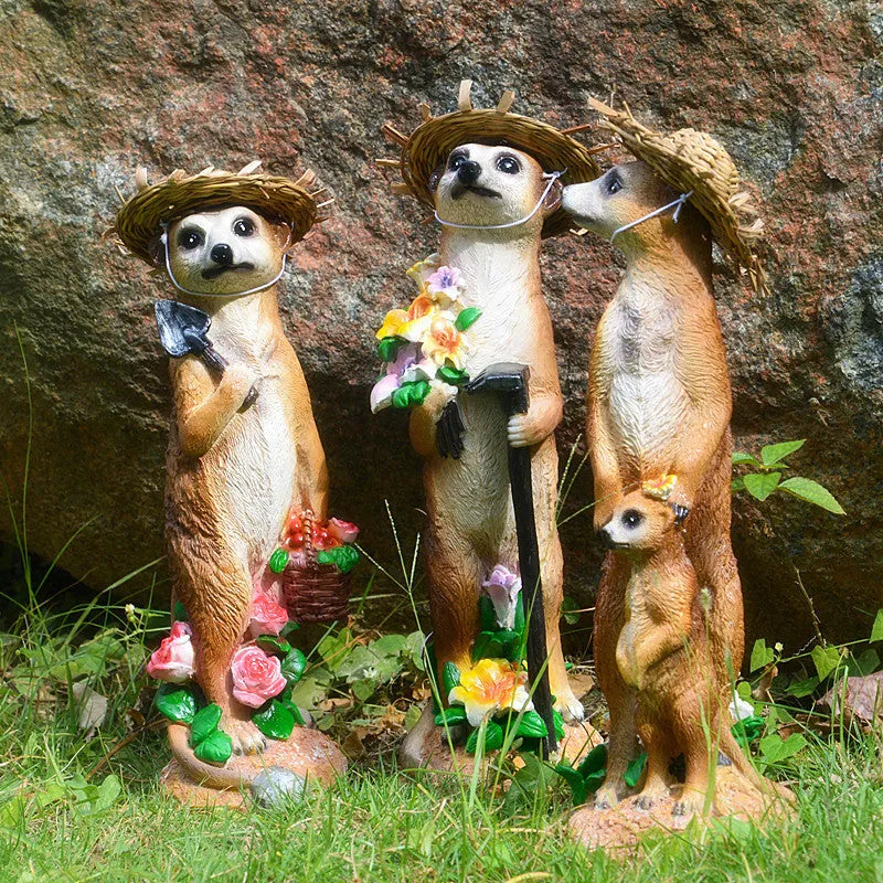 Three resin mongoose garden ornaments with straw hats, including figures holding rake and shovel tools