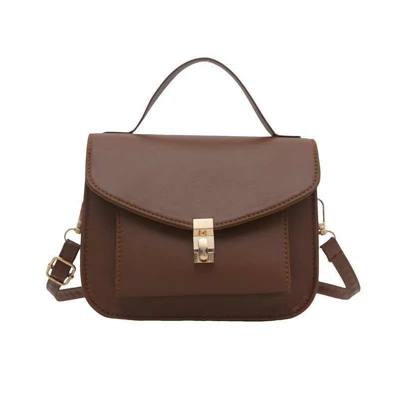 Retro style shoulder messenger bag in horizontal square shape with crossbody strap