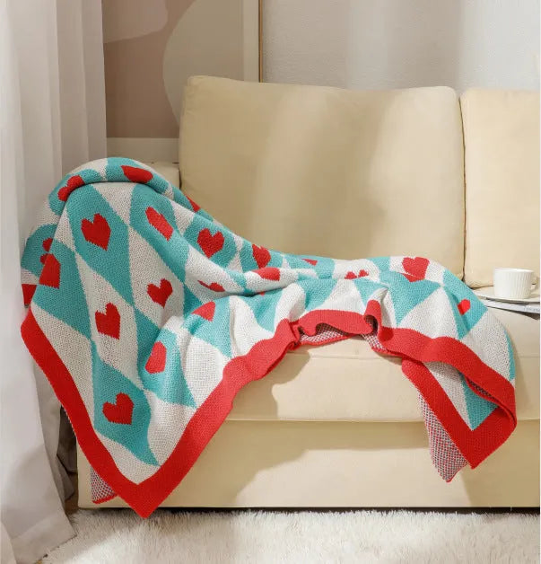 Acrylic sofa blanket with tassel fringe in geometric pattern, showing 130 cm width measurement