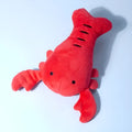 Red plush lobster-shaped squeaky dog toy for small and medium breeds.