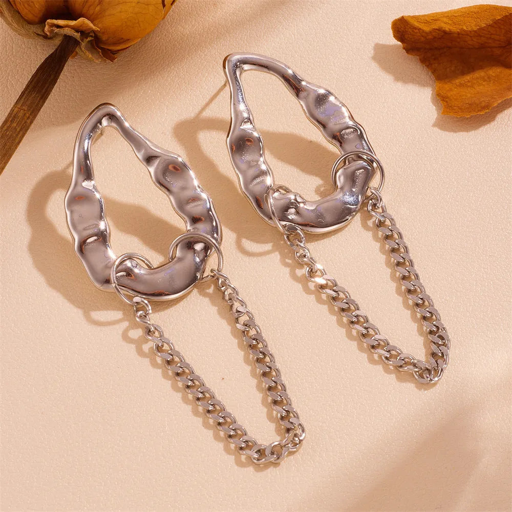 Heart shape titanium steel earrings in gold leaf style on white background
