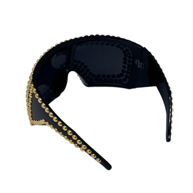 Men's punk sunglasses with large rim and square rivet details in gold colour