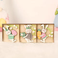 Set of 9 painted wooden Easter pendants with bunny, egg, and owl designs on a light background