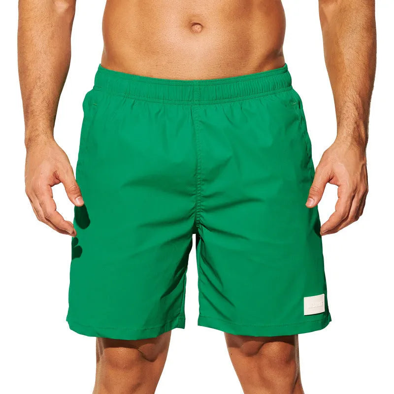 Men's solid colour quick-dry nylon sports shorts on a beach background