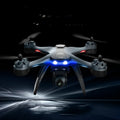 GPS quadrocopter drone with dual cameras, remote controller, spare blades, and landing gear on white background