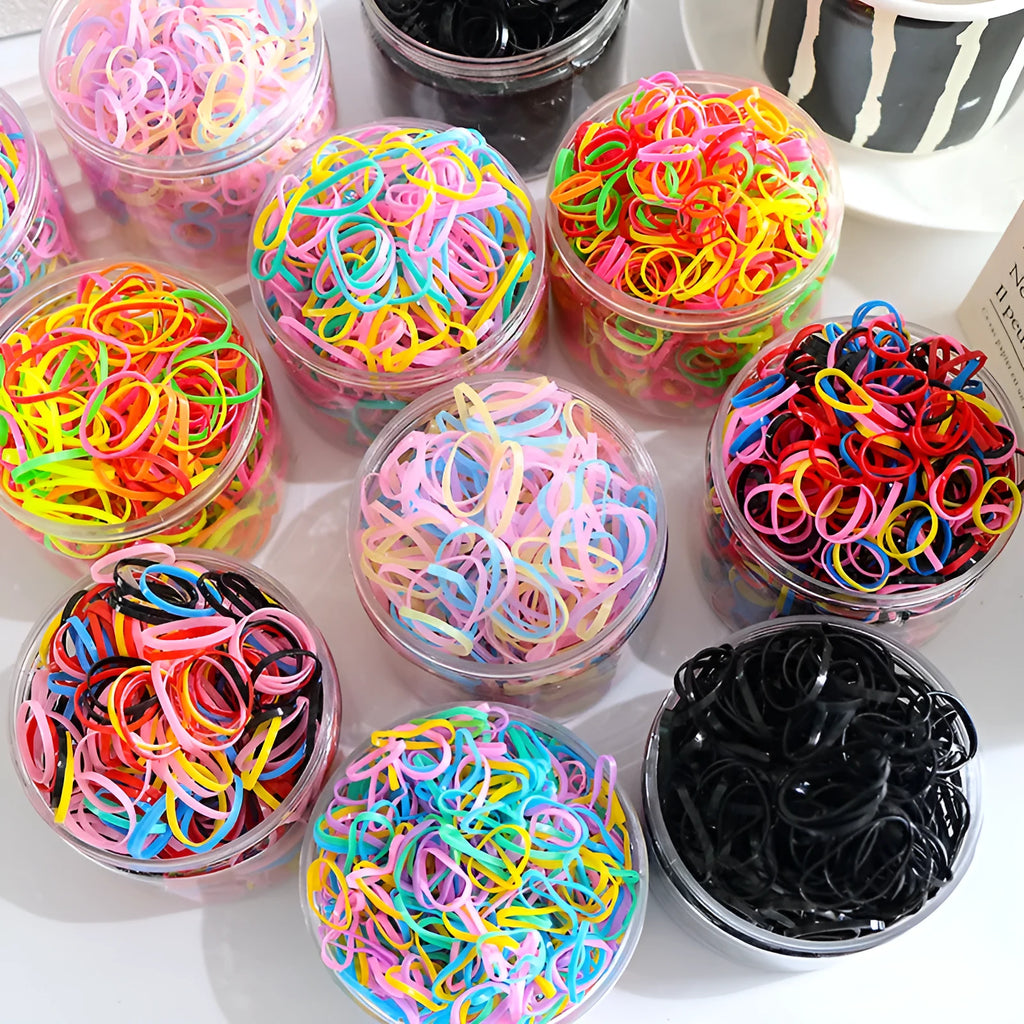 Open reusable container showing hundreds of thin, colourful TPU baby hair ties for toddlers.