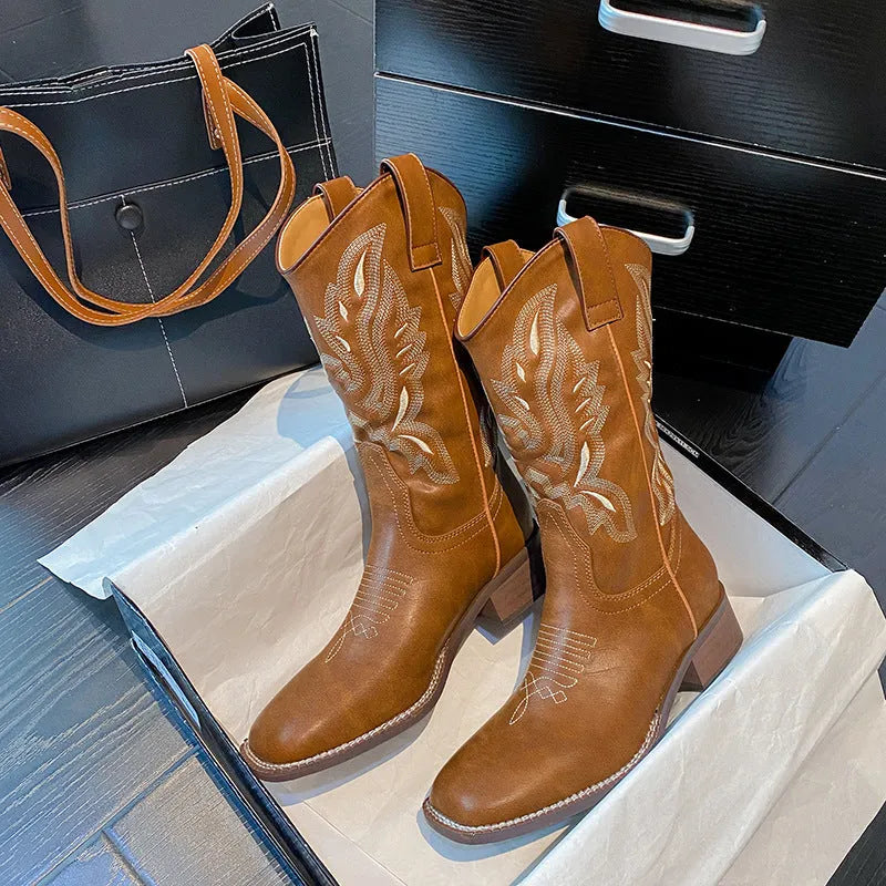 Brown women's mid-calf Martin boots with embroidered detail, round toe, and low square heel.