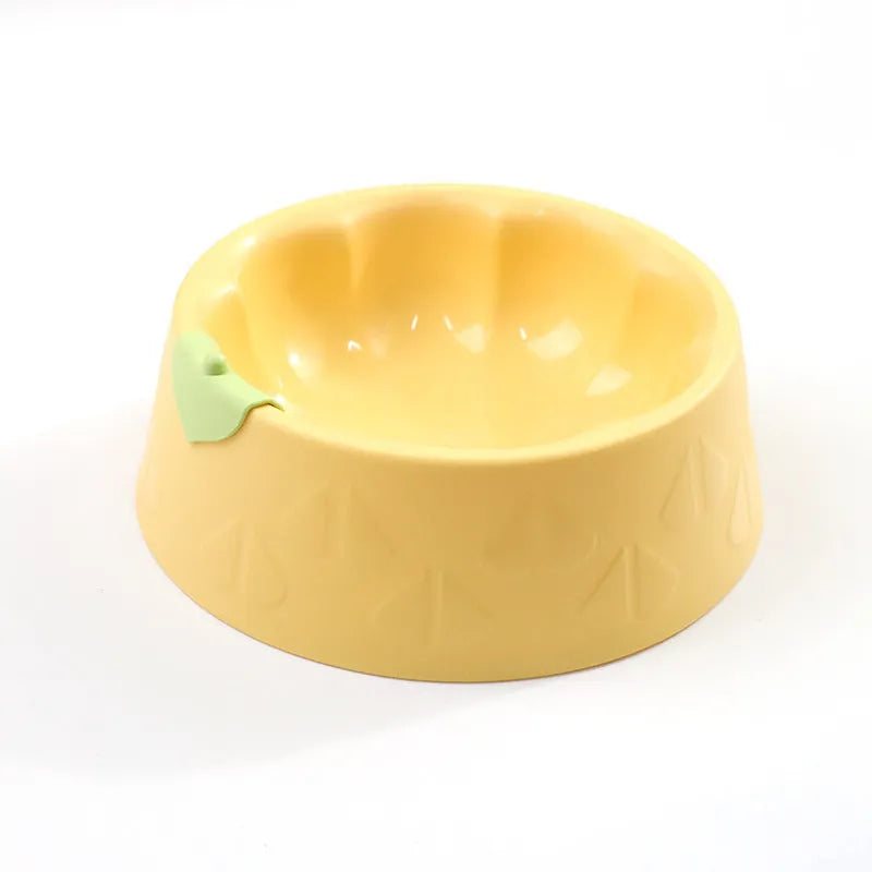 Green plastic double pet bowl for dog and cat food and water on a white surface