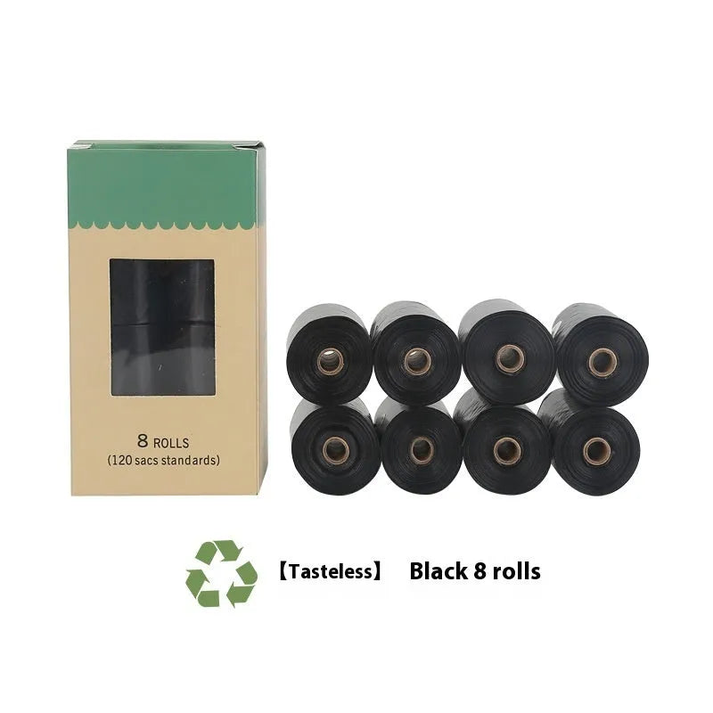 Roll of green EPI degradable dog poo bags next to a white plastic dispenser on a grass background.