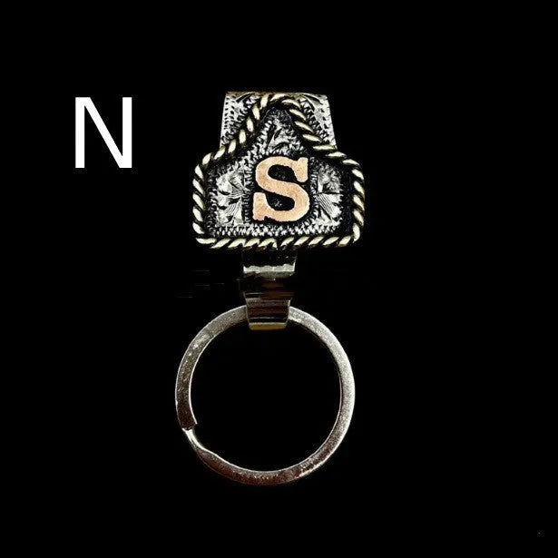 Handmade metal keychain with a cow tag charm in one of 26 available colour options.