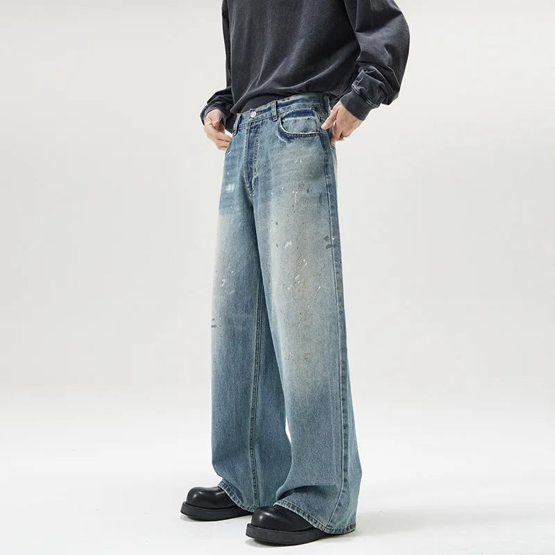 Men's loose fit splash-ink washed denim jeans in Ice Blue on a model, front view
