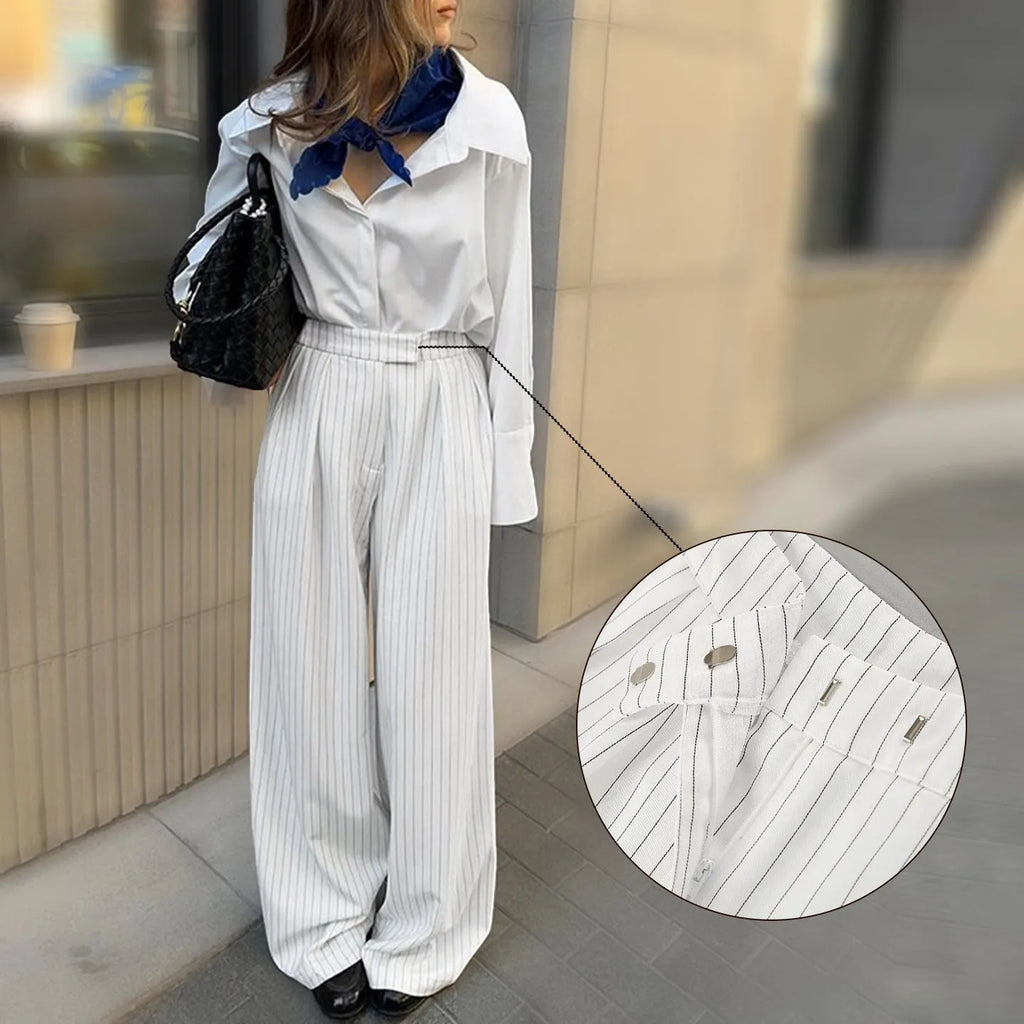 White striped wide-leg casual trousers with a zip closure on a hanger.