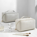 Beige cubic PU vertical pattern pillow makeup bag for travel, showing dimensions of 22.5cm by 12.5cm.