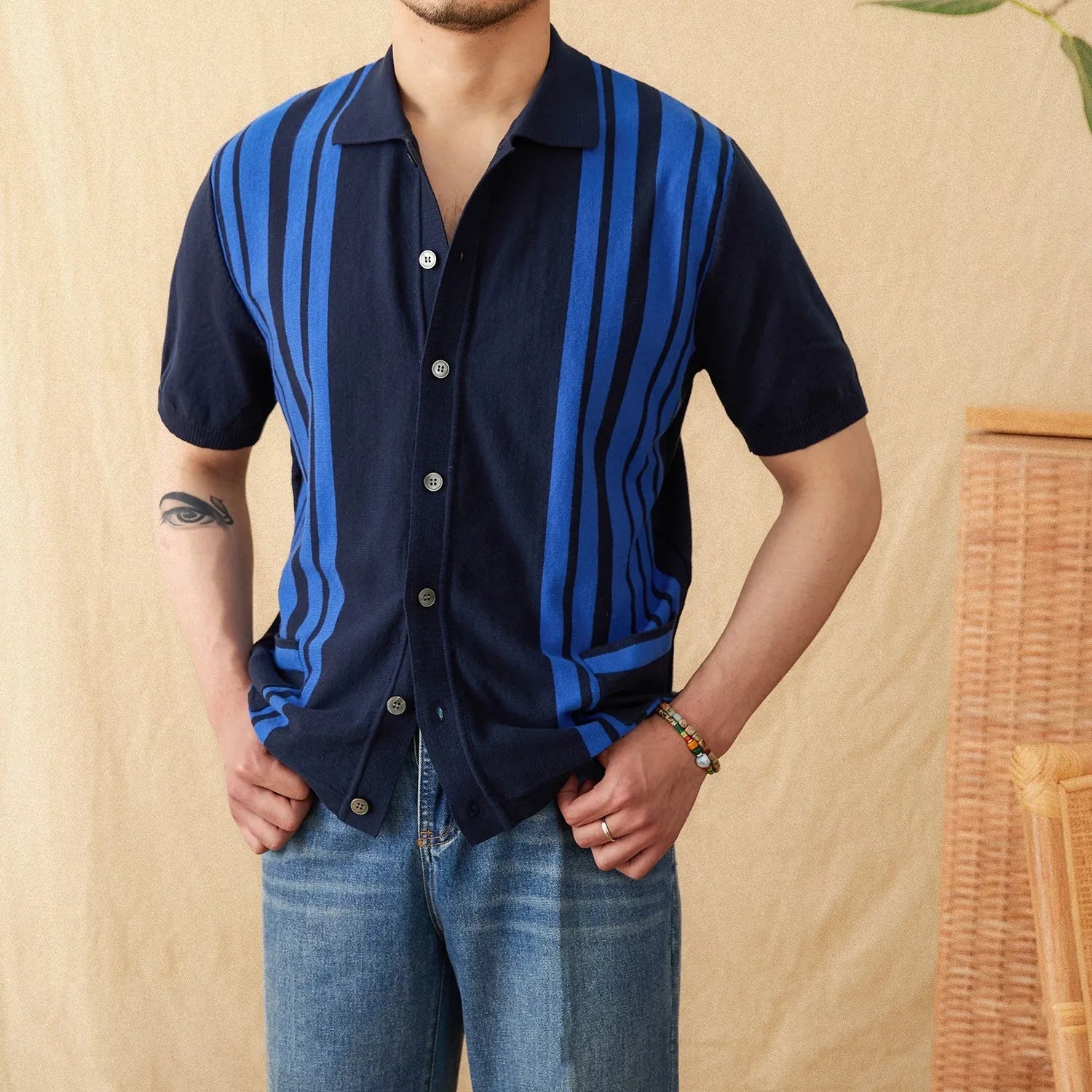 A man's short-sleeved striped cardigan polo shirt with a lapel collar, shown in a light blue colour.