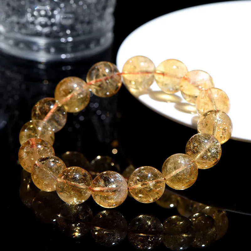 Natural yellow Asestelle citrine bracelet with hand-ground geometry beads on a wrist.