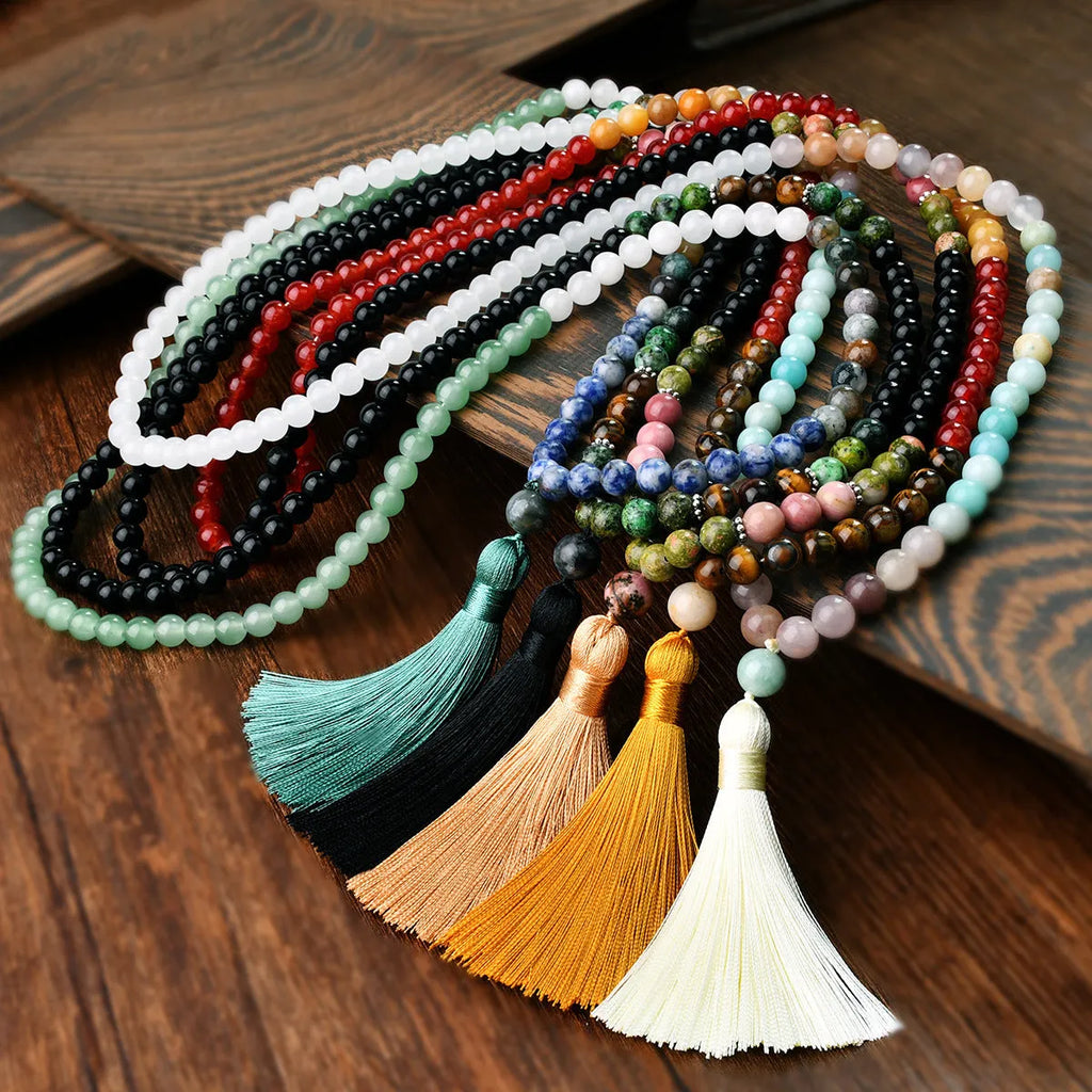 Long bohemian necklace with 108 natural stone beads, a geometric pendant, and a coloured tassel on a ball bead chain.