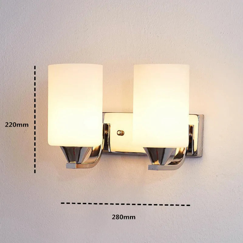 Minimalist chrome-finished glass wall lamp with single head configuration on white wall