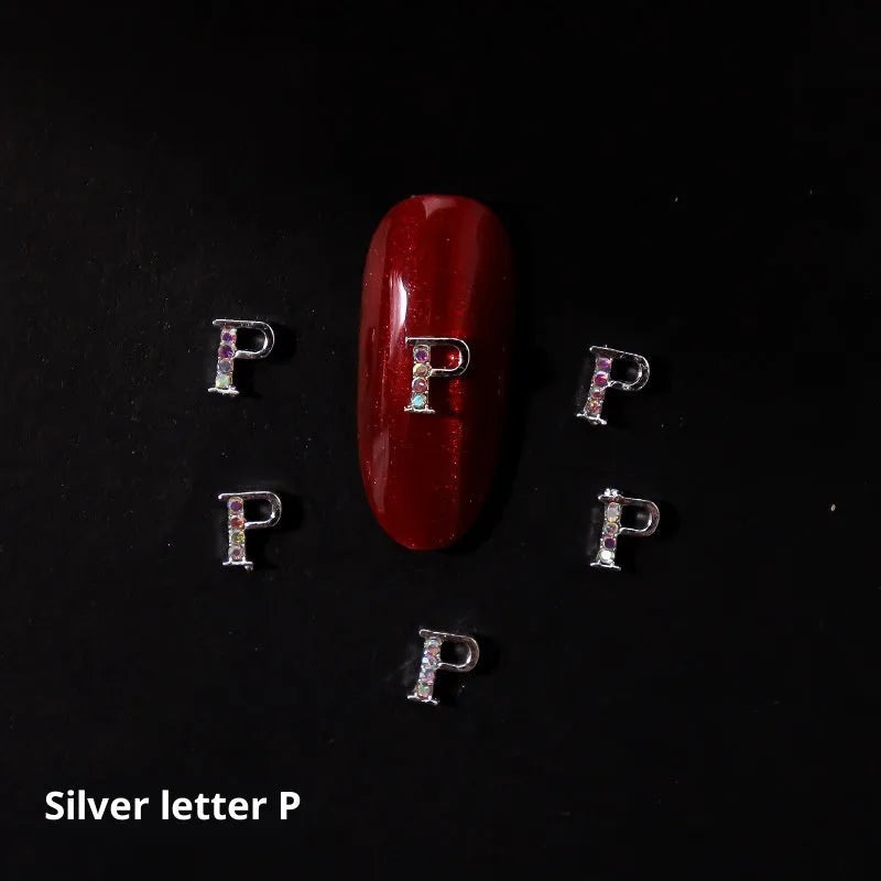 Gold alloy letter A nail ornament charm with crystal detail on a square chain base