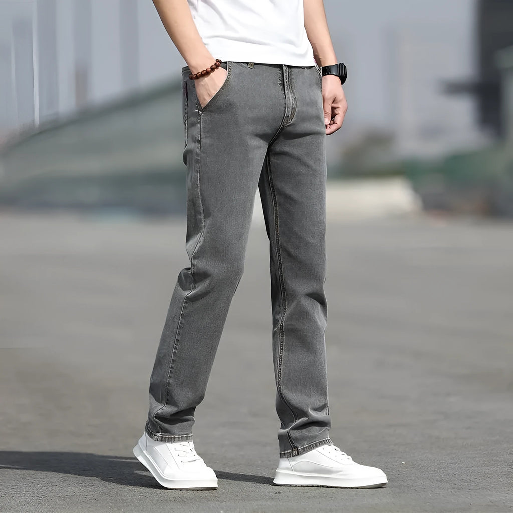 Men's smoky gray straight tube jeans with low waist and zipper fly closure