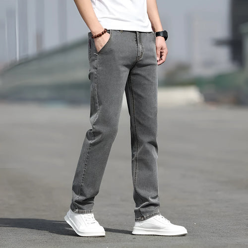 Men's smoky gray straight tube jeans with low waist and zipper fly closure