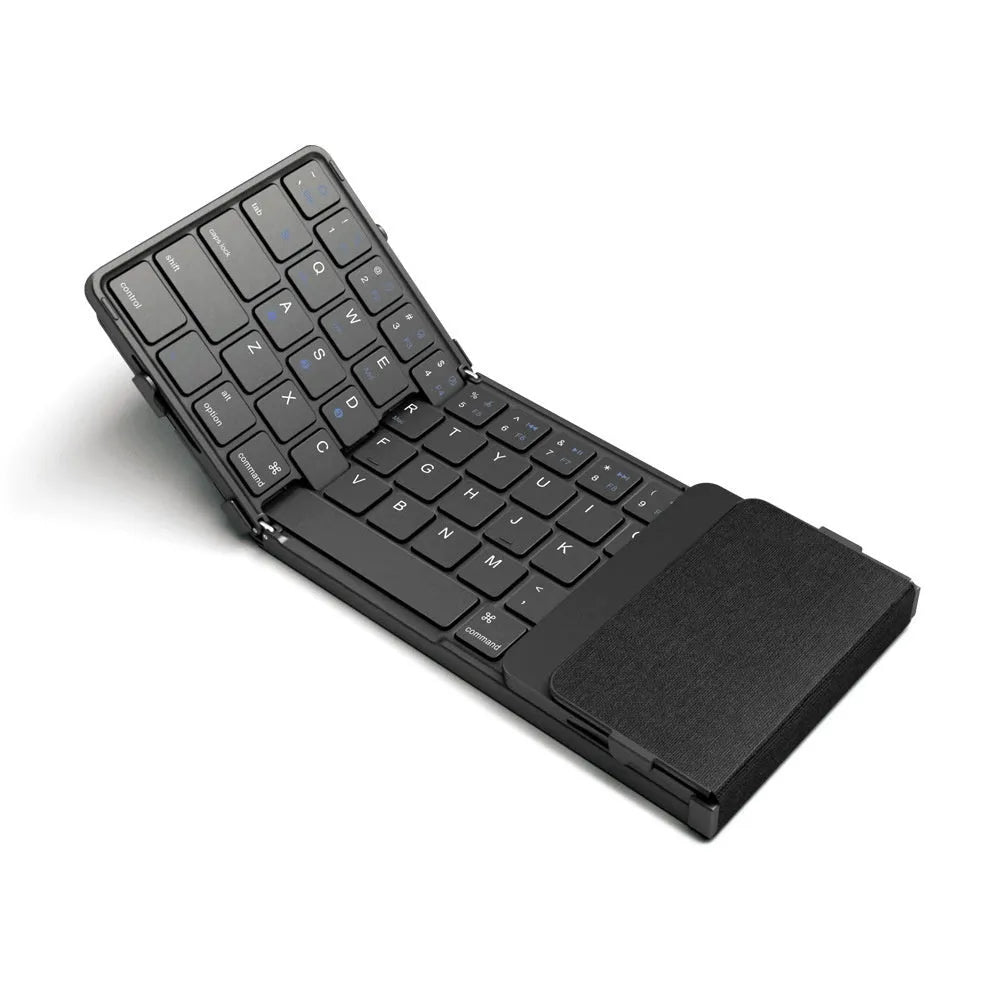 Black folding Bluetooth keyboard with touchpad option next to a mobile phone