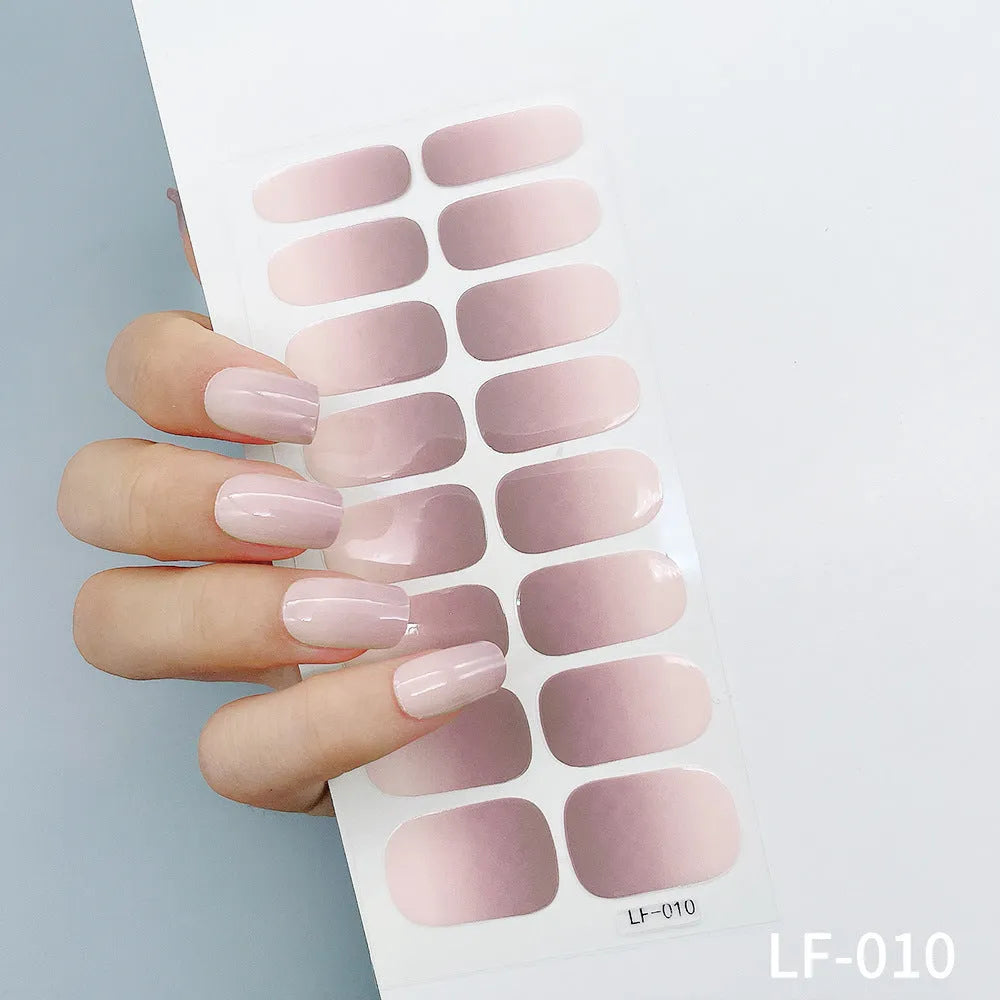Set of 16 solid colour full nail art stickers showing patterns like cross, rose, tulip, and cartoon designs.