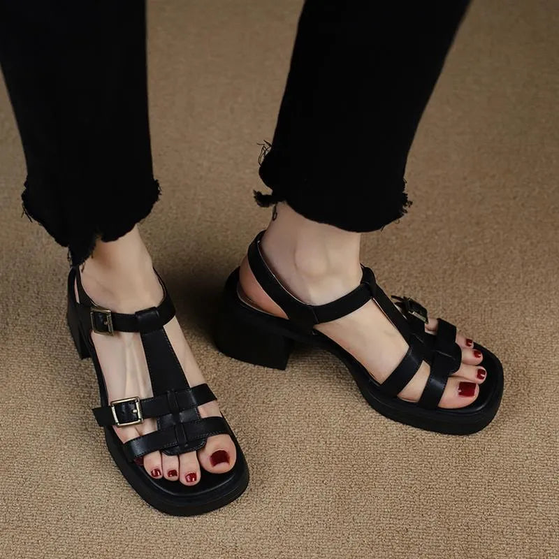 Black retro women's platform sandals with a T-buckle fastening and chunky heel.