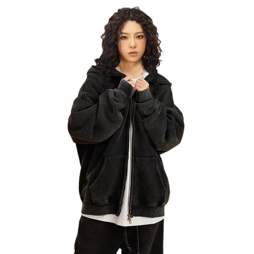 Man wearing a washed black hooded cardigan with a double zipper and fleece lining