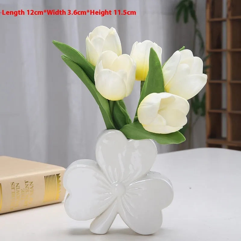 European style white porcelain ceramic vase on a desktop, shown in light green colour.
