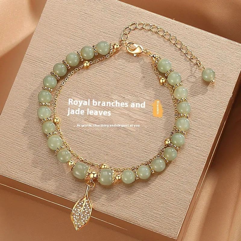 Chinese style glass bracelet with bamboo joint details in a red Lvzhu Duobao design.