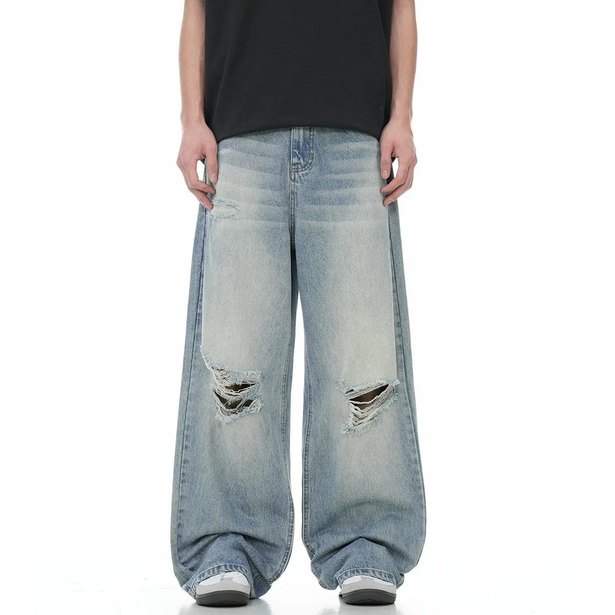 Denim blue straight-leg jeans with ripped details and zip fly closure
