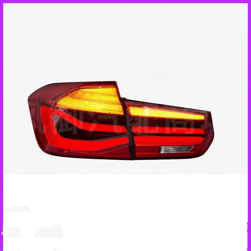 BMW 3 Series modified LED tail light assembly in smoked black finish, showing streamer light pattern.