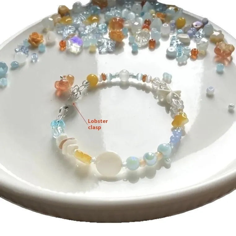Orange seaside-inspired alloy bracelet with diamond charm and round elements showing water-soaked design aesthetic