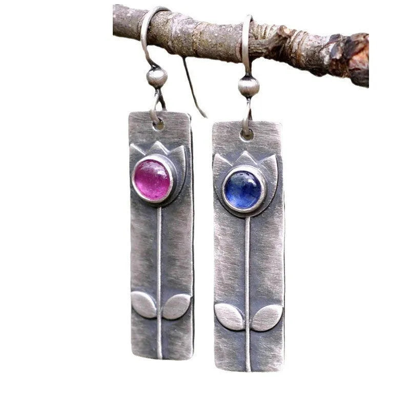 Geometric antique finish earrings with red sapphire detailing and electroplated metal construction