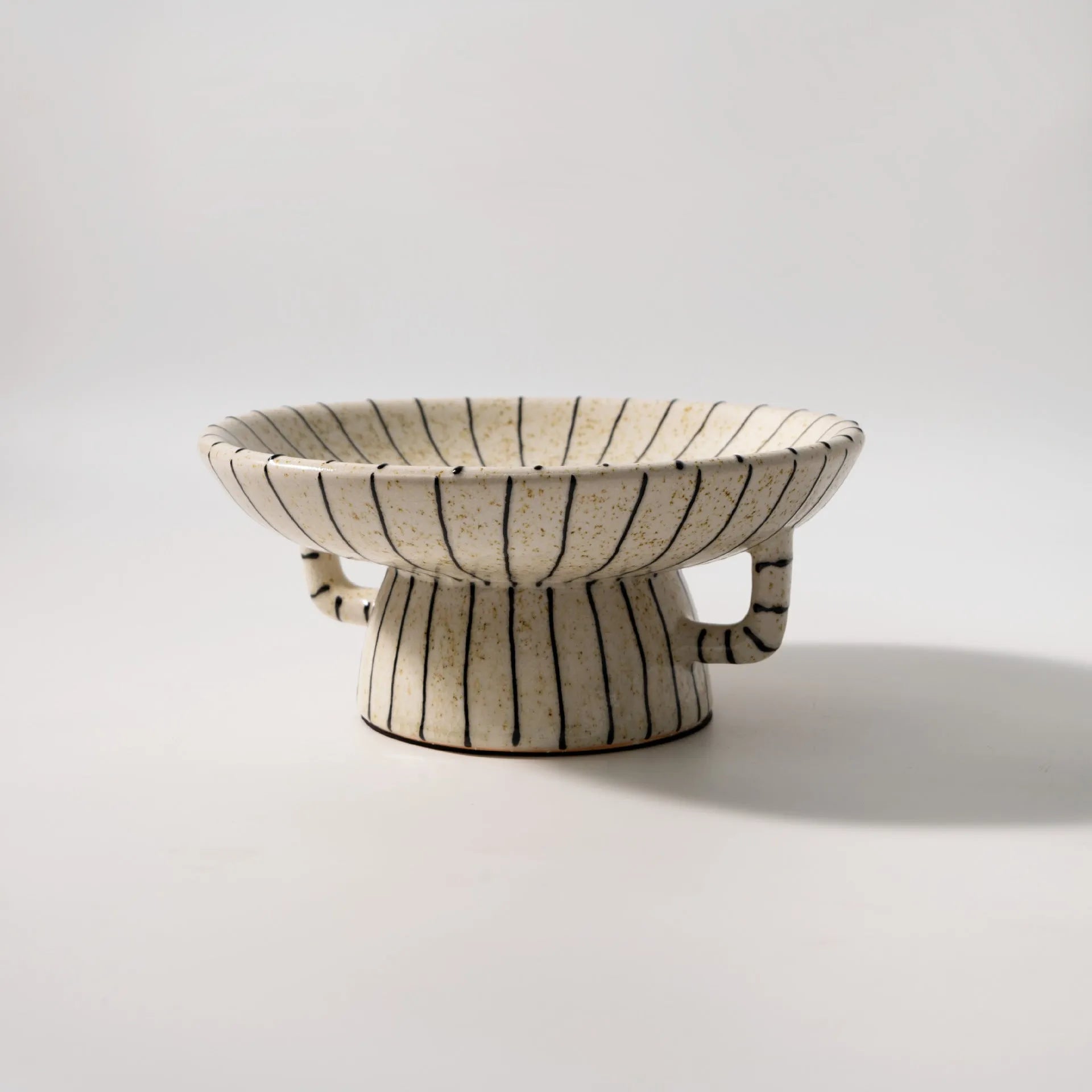 Black and white striped synthetic resin fruit plate or dessert plate on a table