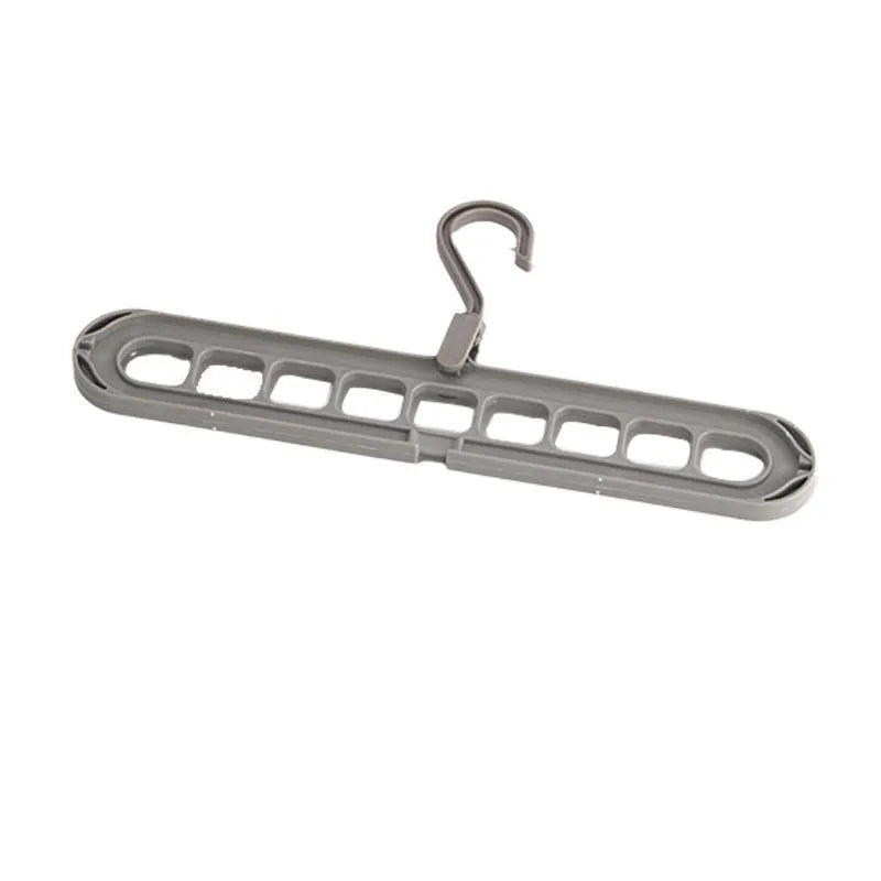Green plastic nine-hole folding hanger for trousers displayed open and folded flat.