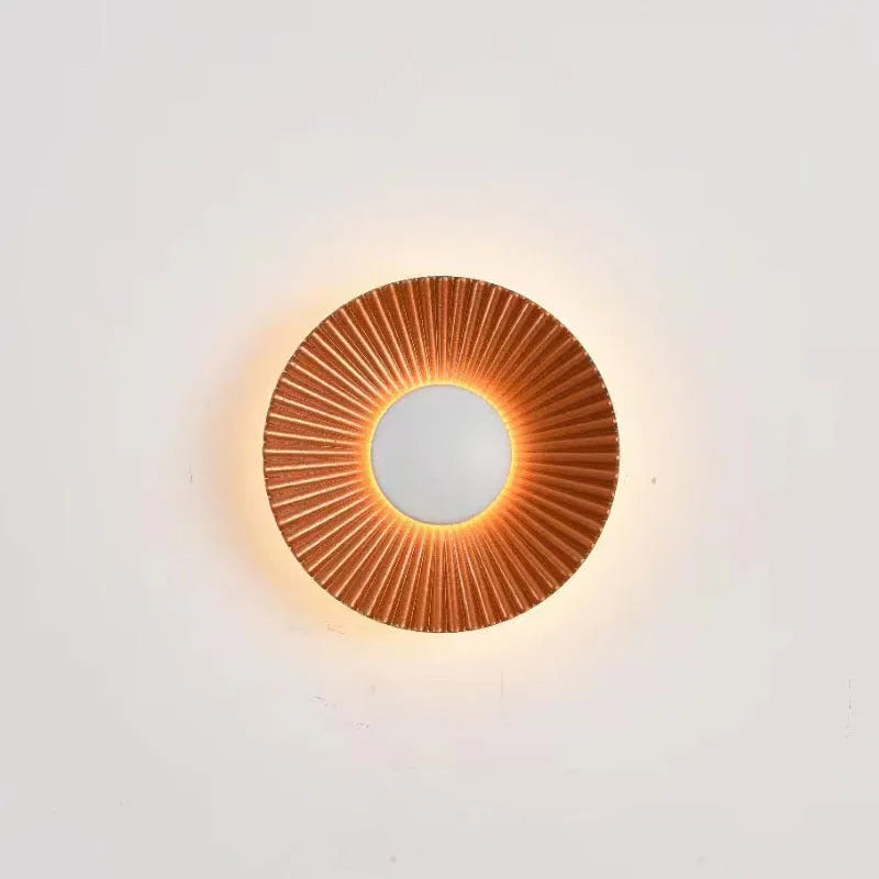 Round aluminium LED wall lamp in a dual-colour finish mounted on a wall.