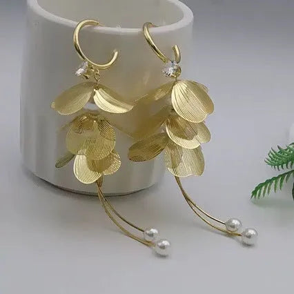 Gold floral petal pearl fringe drop earrings with electroplated alloy finish on neutral background