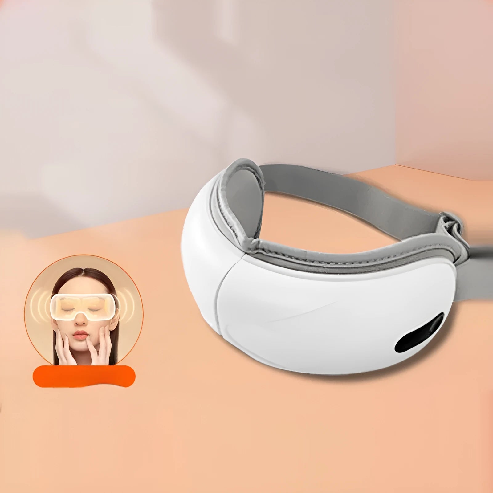 White rechargeable eye massager with hot compress and airbag massage functions on a grey background