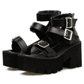 Black women's punk-style sandals with chunky heel, round toe, back zipper, and decorative buckle.