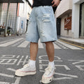 Light blue ripped denim shorts with a loose, straight-leg fit on a neutral background.