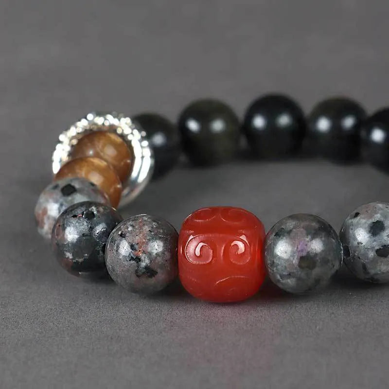 Gold obsidian flame stone red agate Wukong unisex bracelet on display showing natural stone beads