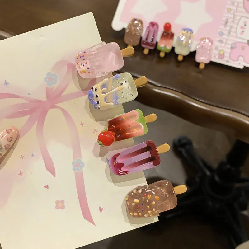 Close-up of a handmade resin hair barrette with a cute cartoon ice cream design in a choice of colours.