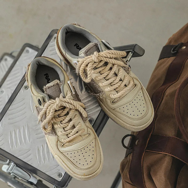 Beige vintage patch skateboard shoes with lace-up closure and low-top design